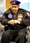 Retired U.S. Navy Chief Warrant Officer 4 Solomon Atkinson quietly waits in his wheelchair wearing his SEAL insignia, an eagle perched on a horizontal three-pronged trident, clutching a pistol, with an upright anchor, on his purple beret and decade’s worth of ribbons adorning his jacket before receiving the Alaska Governor’s Veteran Advocacy Award during a ceremony in Metlakatla, Alaska, Dec. 10, 2018.