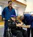 Retired U.S. Navy Chief Warrant Officer 4 Solomon Atkinson, center, is greeted by Verdie Bowen, right, the director of the Alaska Office of Veterans Affairs, and escorted by son-in-law Franklin Hayward before receiving the Alaska Governor’s Veteran Advocacy Award during a ceremony in Metlakatla, Alaska, Dec. 10, 2018. Atkinson returned to his native Alaska after 22 years of Naval service in 1976, continuing to serve his community on the Indian Community Council and Board of Education, as a founder and president of the first veteran’s organization on Annette Island, and as mayor of Metlakatla.