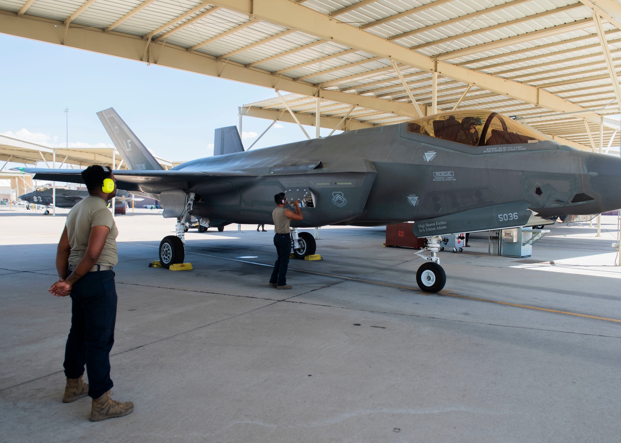 U.S. Air Force Capt. Audrey Wilson, 56th Training Squadron student pilot (right), Staff Sgt. Brian Chavis, 56th Aircraft Maintenance Squadron crew chief (left), and Airman 1st Class Jacob Nault, 63rd Aircraft Maintenance Unit crew chief (middle), complete final pre-flight checks for a U.S. Air Force F-35 Lightning II Aug. 3, 2023, at Luke Air Force Base, Arizona.