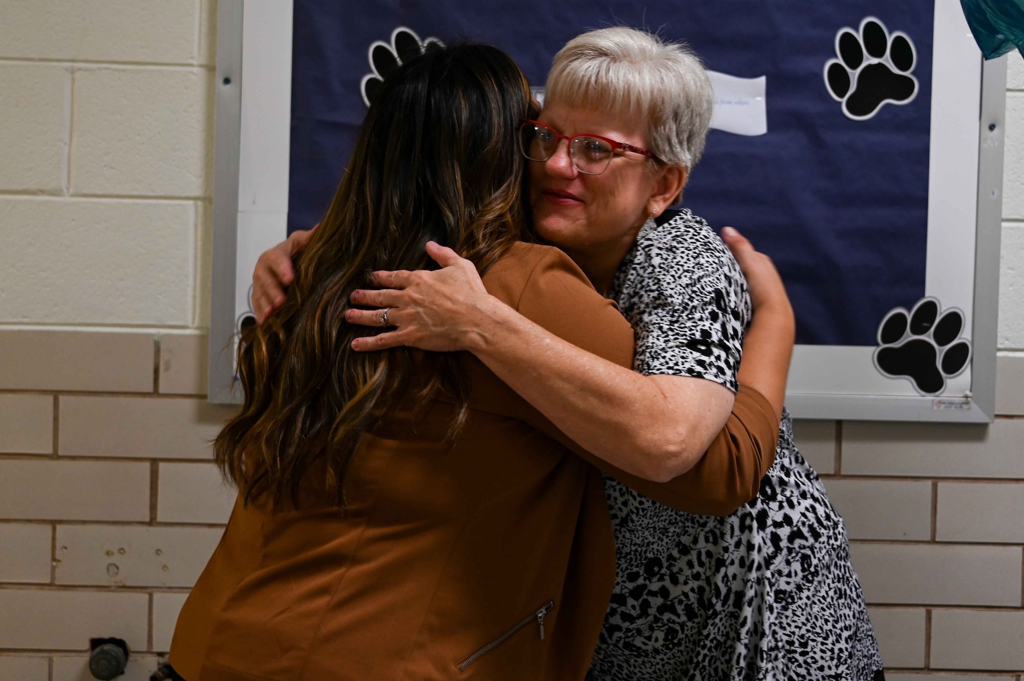 Gwendolyn Brakebill, 97th Force Support Squadron school liaison program manager, hugs Paula Davis, a teacher’s aide at L. Mendel Rivers Elementary School, Altus, Oklahoma, Aug. 7, 2023. Brakebill said she wanted to move into the school liaison program manager position to ensure easier transitions into schools for service members and their children. (U.S. Air Force photo by Airman 1st Class Kari Degraffenreed)