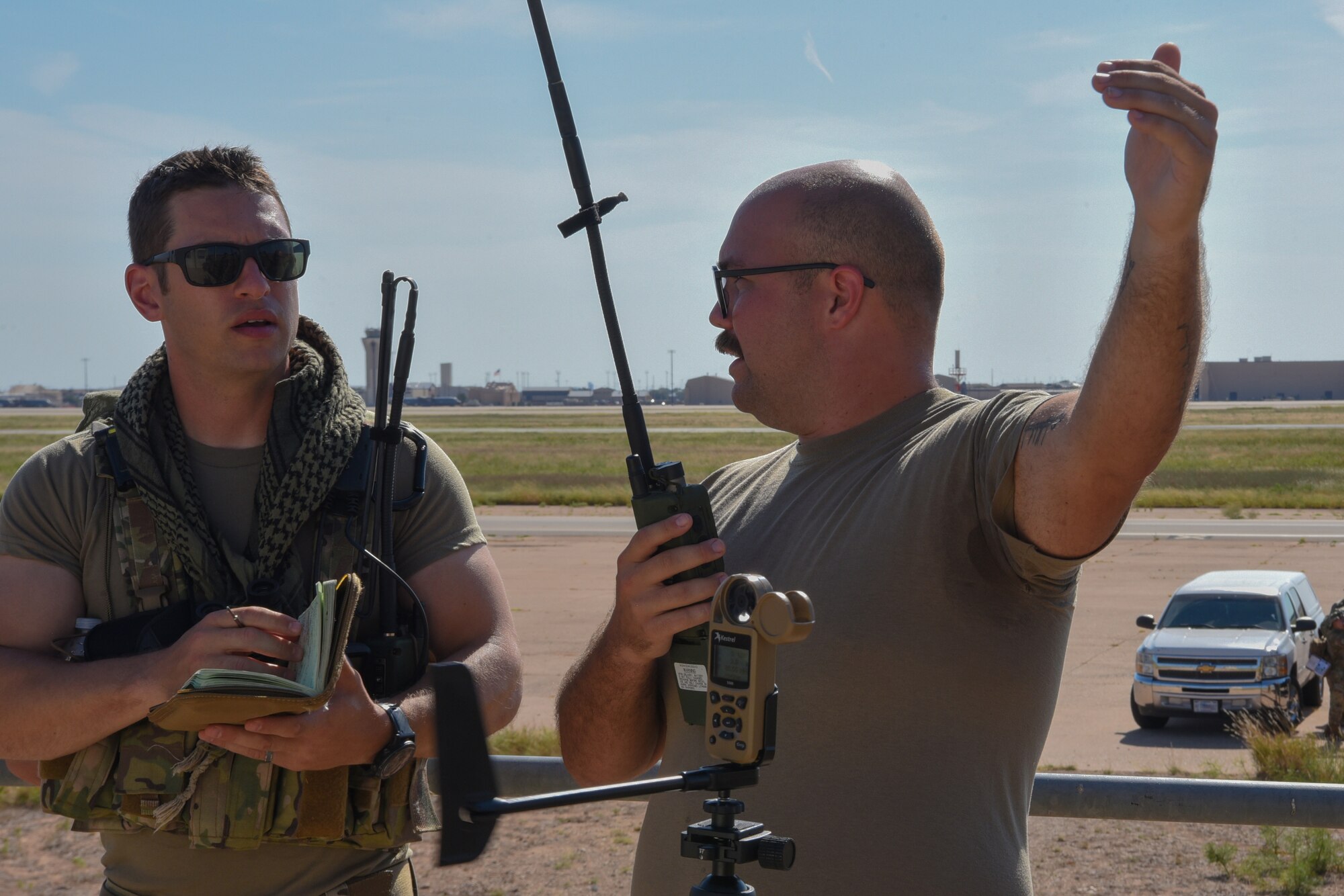 Master Sgt. Levi Rodney, 435th Training Squadron Landing Zone Safety Officer course instructor, engages with Tech. Sgt. Dylan Mullen, 7th Operations Support Squadron airfield management operations supervisor, at Dyess Air Force Base, Texas, Aug. 2, 2023. Airmen within the LZSO course learned skills that combat controllers use in austere environments, such as establishing small landing surfaces and controlling aircraft for landing. (U.S. Air Force photo by Senior Airman Sophia Robello)