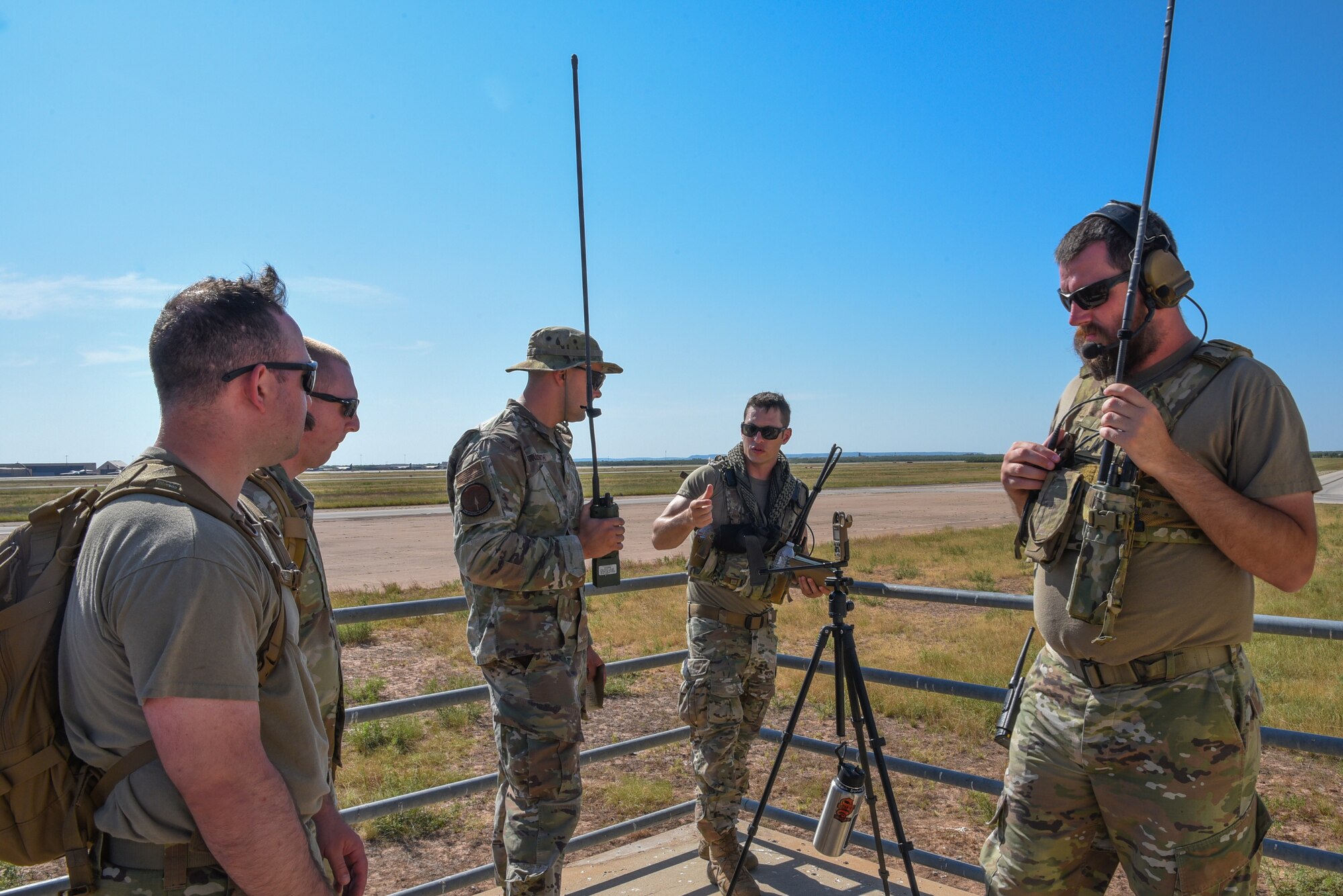 Master Sgt. Levi Rodney, 435th Training Squadron Landing Zone Safety Officer course instructor, engages with Tech. Sgt. Dylan Mullen, 7th Operations Support Squadron airfield management operations supervisor, at Dyess Air Force Base, Texas, Aug. 2, 2023. Airmen within the LZSO course learned skills that combat controllers use in austere environments, such as establishing small landing surfaces and controlling aircraft for landing. (U.S. Air Force photo by Senior Airman Sophia Robello)