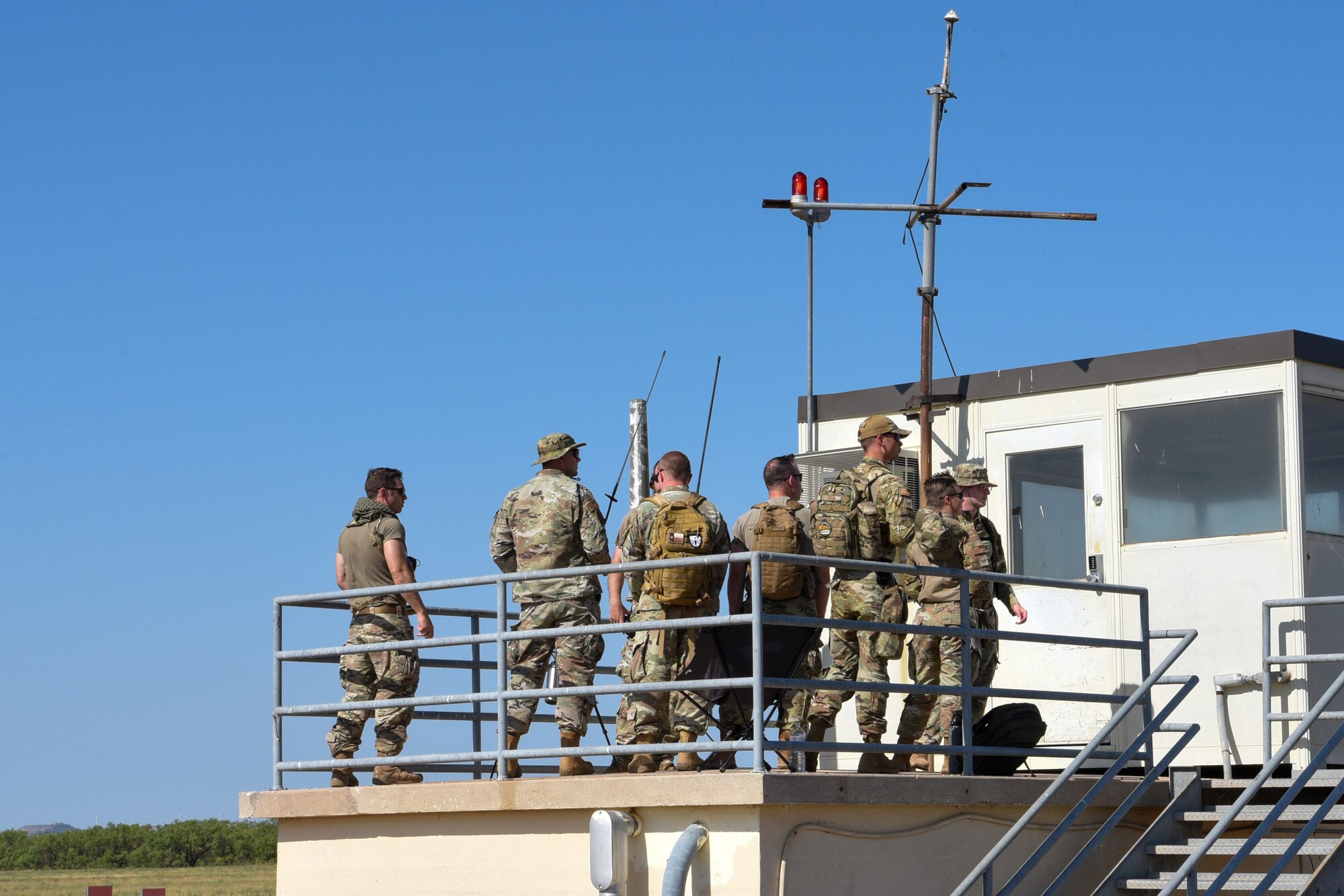 Students and instructors from the Landing Zone Safety Officer communicate with a C-130J Super Hercules via mobile radio at Dyess Air Force Base, Texas, Aug. 2, 2023. This iteration marked the first time this type of course was held at Dyess, enhancing unit readiness and limiting members’ time away from mission requirements. (U.S. Air Force photo by Senior Airman Sophia Robello)