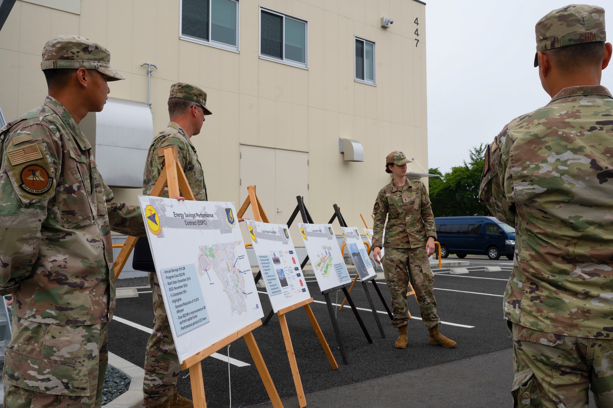 Military members discussing what all goes into making a liquid natural gas plant work.