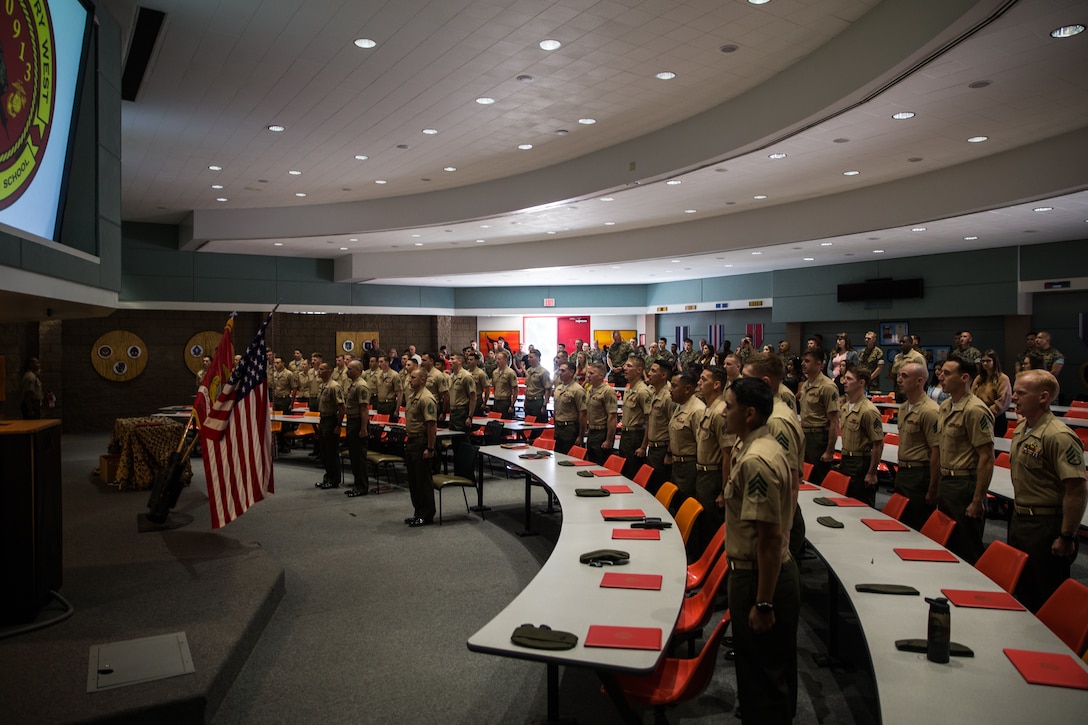 U.S. Marines with the Combat Instructor School Class 4-19, School of Infantry - West, sing “The Marines’ Hymn,” during a graduation ceremony on Marine Corps Base Camp Pendleton, California, Sept. 12, 2019. The mission of CIS is to develop Marines’ leadership, character, knowledge and fitness to fortify them with skills required to succeed as a combat instructors. CIS is a nine-week course that provides Marines with knowledge of the rules, regulations and procedures to prepare them to lead and instruct entry-level Marines during combat training. (U.S. Marine Corps photo by Lance Cpl. Alison Dostie)