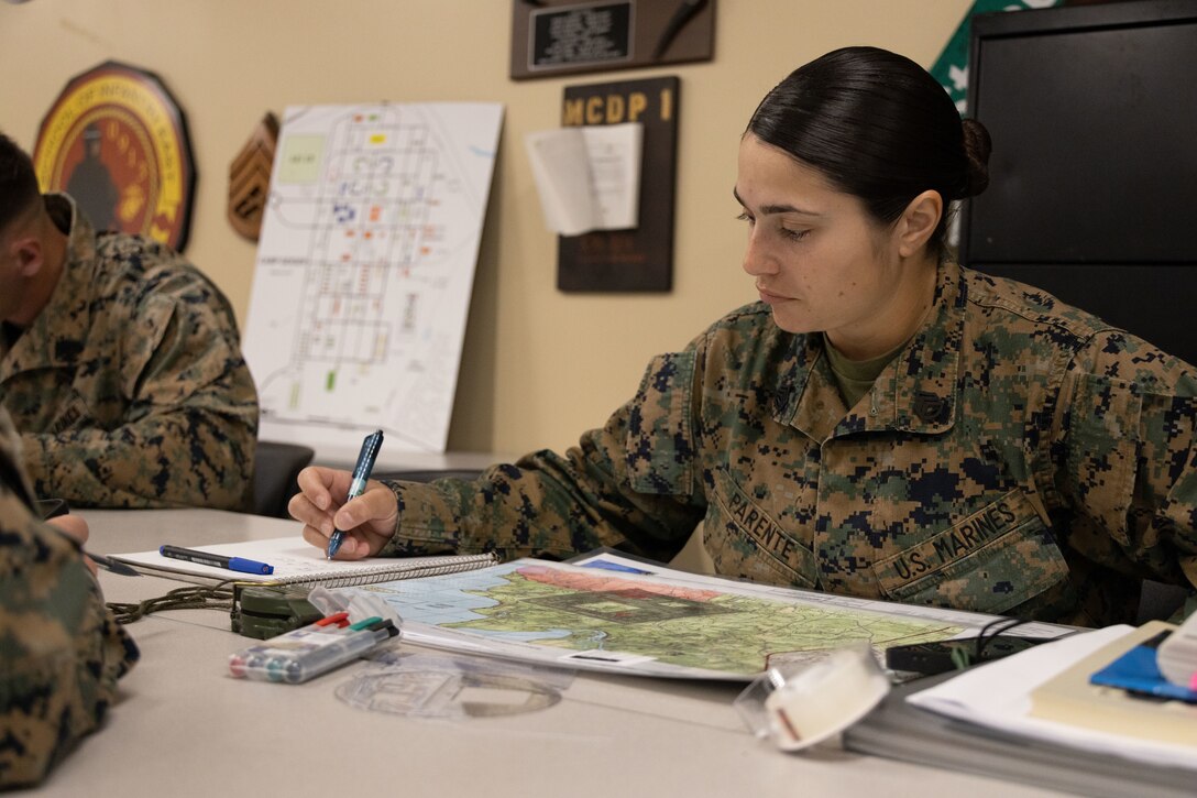 U.S. Marine Corps SSgt. Rosalba N. Parente, a student with the School of Infantry-East, Combat Instructor School, researches separate components of land navigation at Camp Geiger, N.C., Jan. 30, 2023. The Marine Corps Combat Instructor School trains and evaluates student based on their ability to perform and teach Marines with Marine Combat Training. (U.S. Marine Corps photo by Lance Cpl. Alexis A. Ballin)