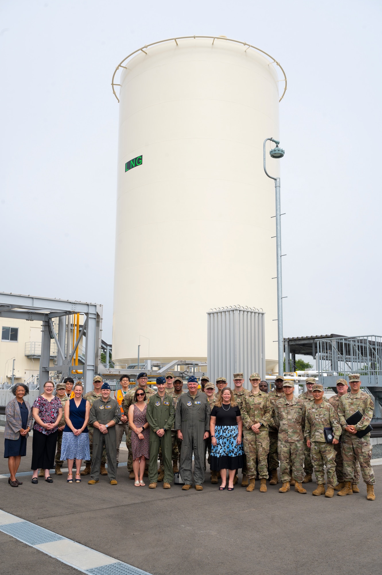 Team Misawa members pose for a photo in front of a liquid natural gas plant.