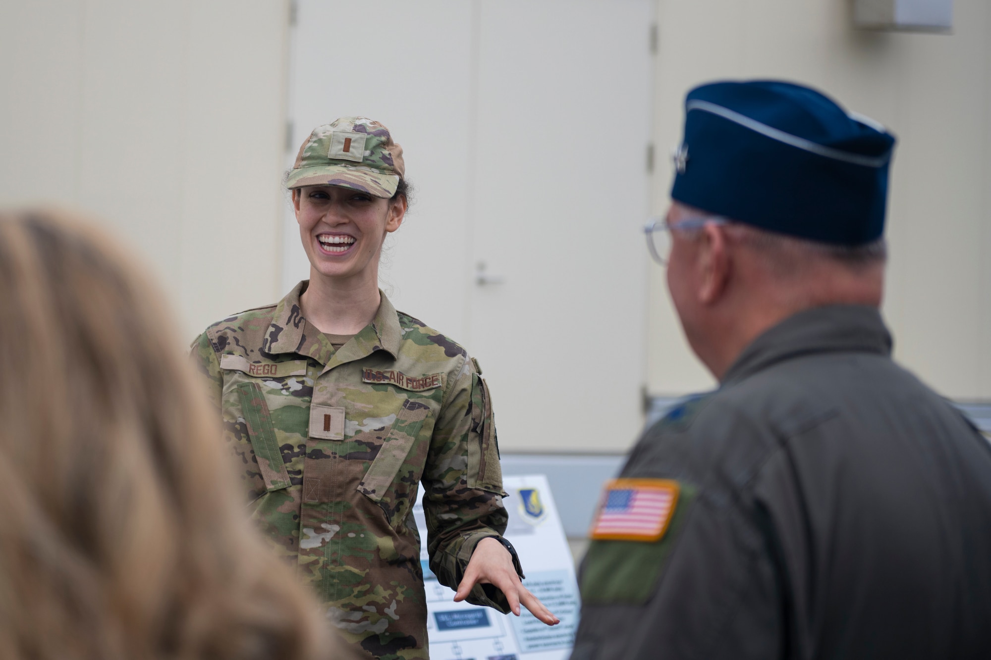 Military member laughing during a briefing.
