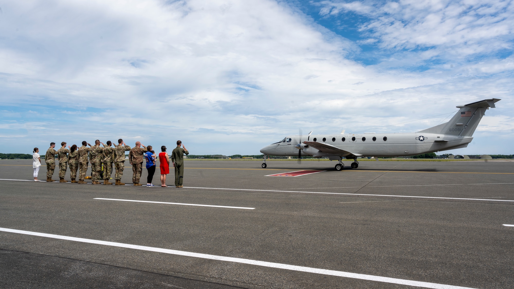 Team Misawa members on the flightline render a farewell salute as U.S. Air Force Lt. Gen. Ricky Rupp.