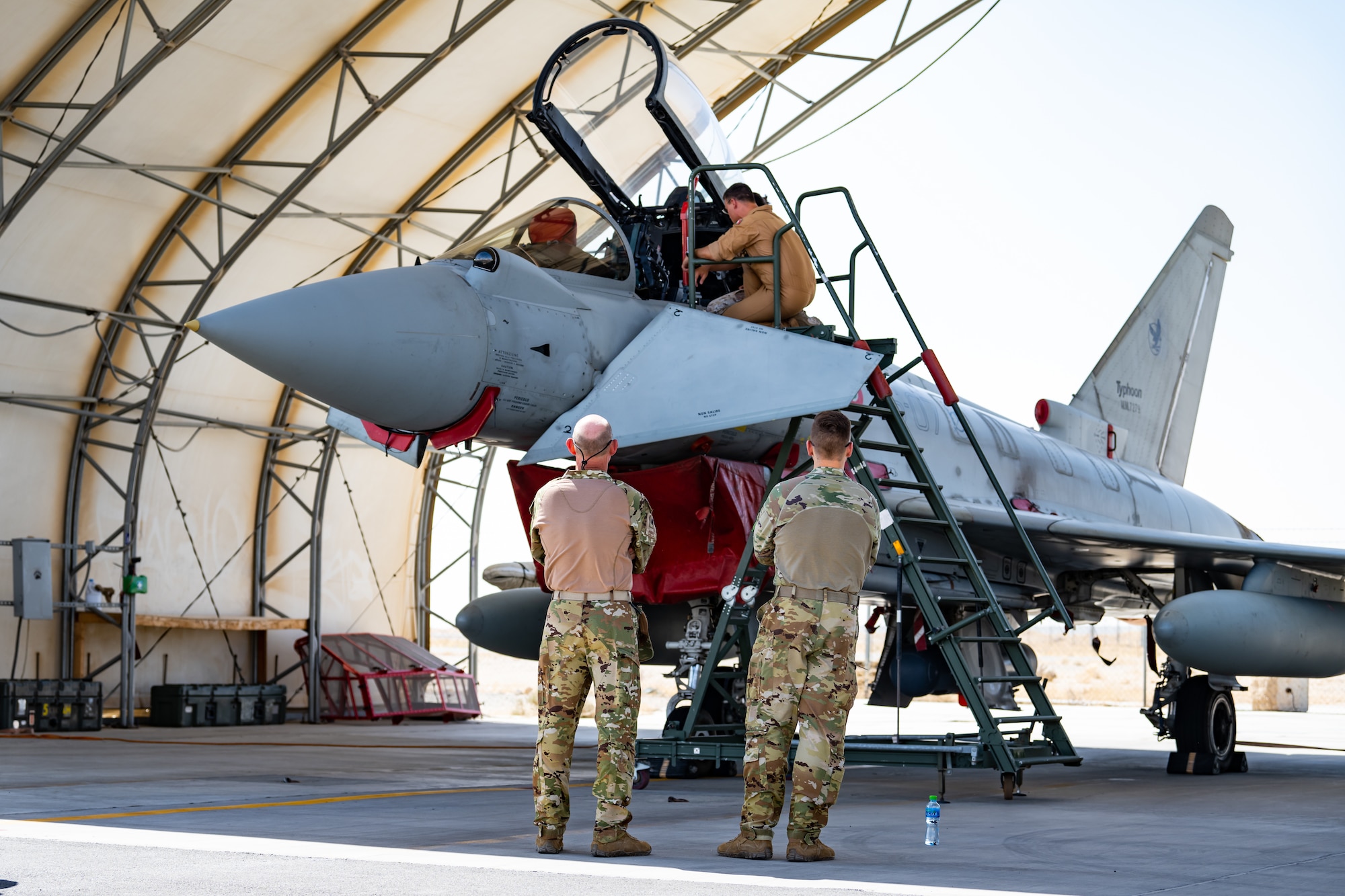 U.S. Air Force service members assigned to the 386th Air Expeditionary Wing take a close look at an Italian Air Force Eurofighter Typhoon at Ali Al Salem Air Base, Kuwait, Aug. 4, 2023. Our Italian Air Force counterparts opened their doors to all of the coalition partners here for this unique educational opportunity, increasing the interoperability of our forces and enhancing our ability to project decisive combat power together across the theater. (U.S. Air Force photo by Staff Sgt. Kevin Long)
