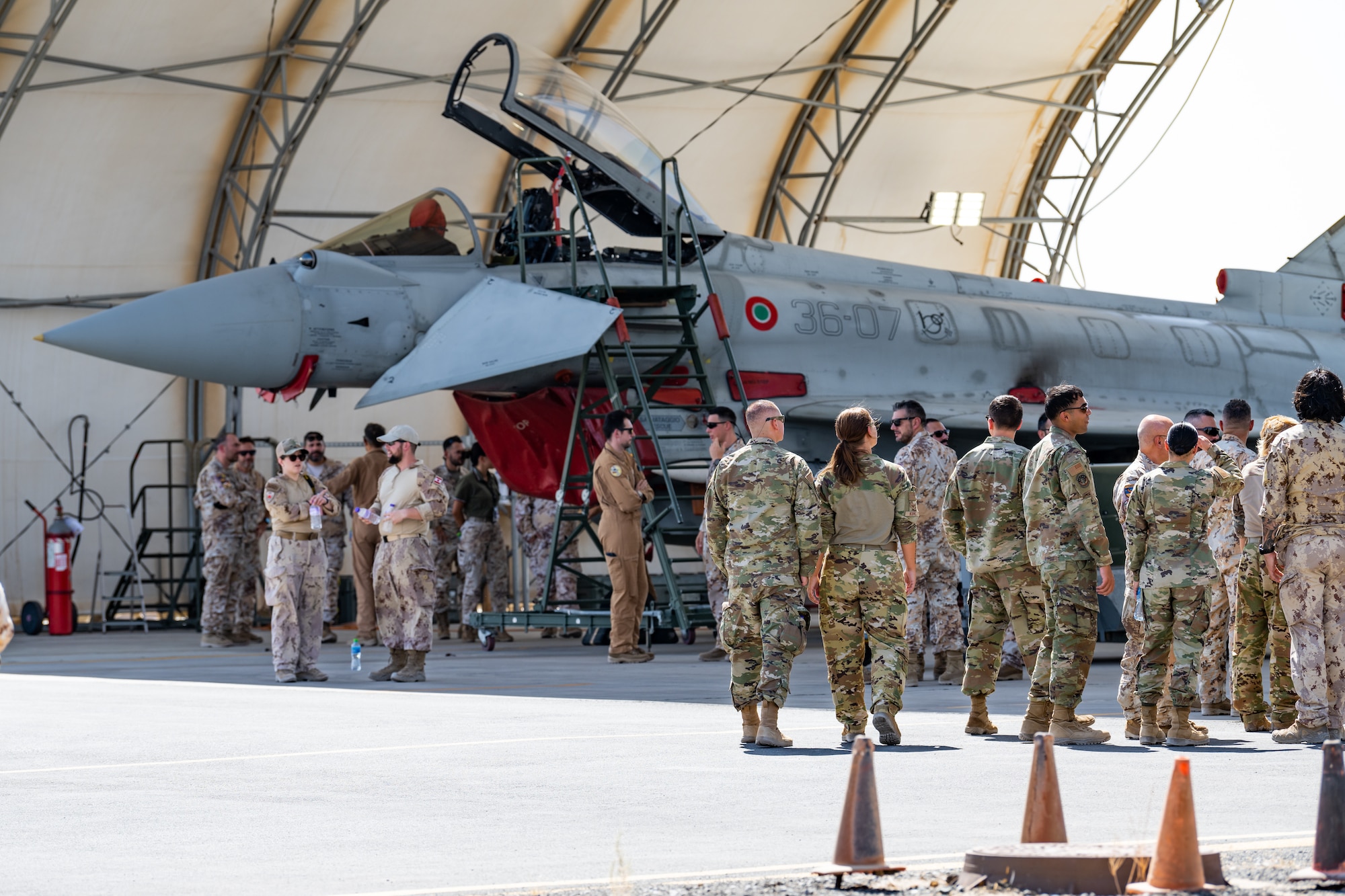 U.S. and Canadian service members take part in an immersion with the Italian Air Force to learn more about their Eurofighter Typhoon mission at Ali Al Salem Air Base, Kuwait, Aug. 4, 2023. Our Italian Air Force counterparts opened their doors to all of the coalition partners here for this unique educational opportunity, increasing the interoperability of our forces and enhancing our ability to project decisive combat power together across the theater. (U.S. Air Force photo by Staff Sgt. Kevin Long)