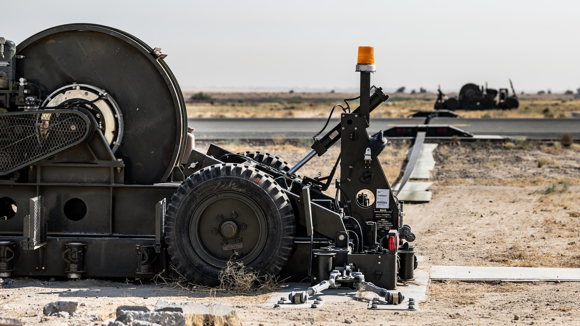 A Mobile Aircraft Arresting System (MAAS) lays ready to receive a Kuwait Air Force F/A-18 Super Hornet at Ali Al Salem Air Base, Kuwait, July 10, 2023. This certification event was beneficial to both the U.S. and Kuwait as the MAAS was certified to provide enhanced stopping power to inbound aircraft, and the Kuwait Air Force received more experience hooking up to the system. (U.S. Air Force photo by Staff Sgt. Kevin Long)