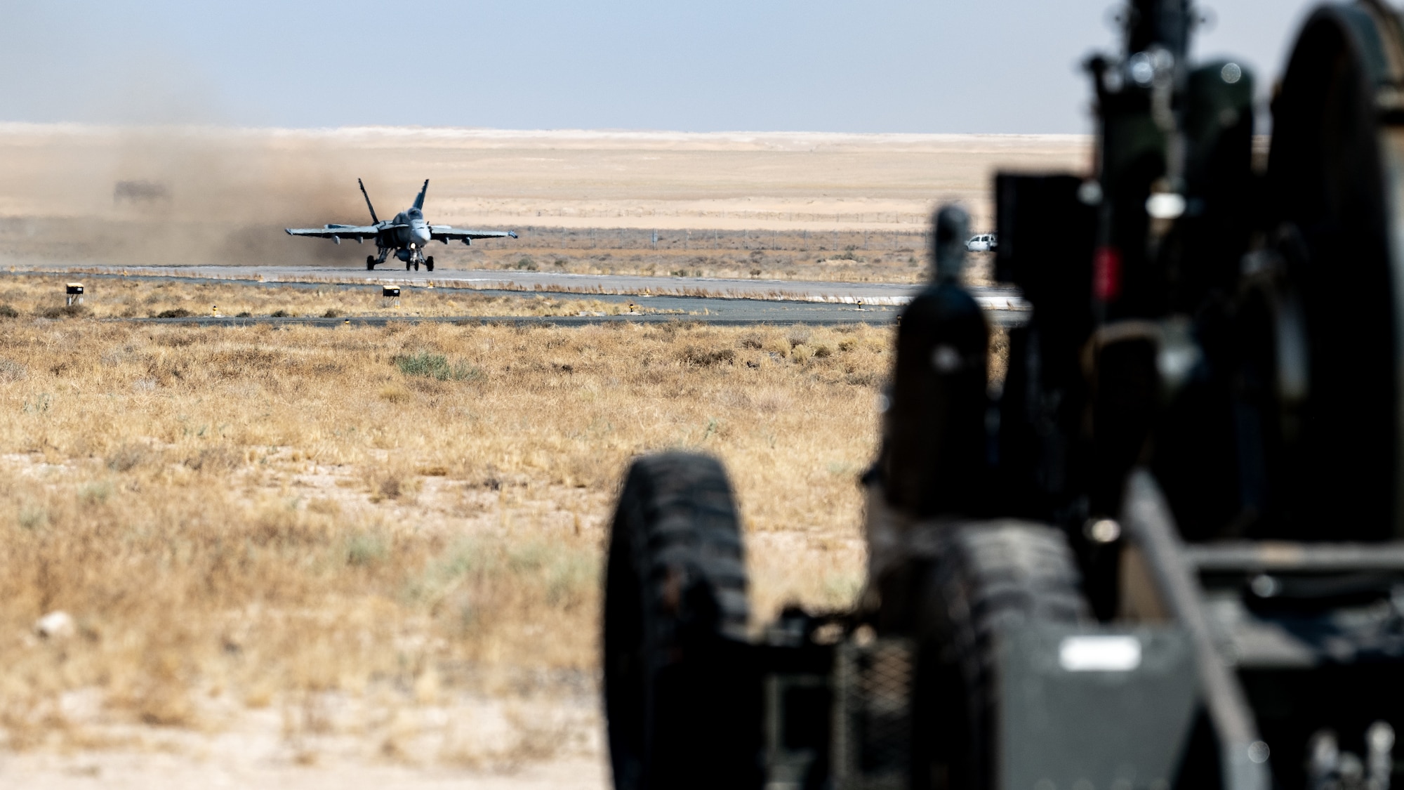 A Kuwait Air Force F/A-18 Super Hornet speeds down the runway towards a Mobile Aircraft Arresting System (MAAS) at Ali Al Salem Air Base, Kuwait, July 10, 2023. This certification event was beneficial to both the U.S. and Kuwait as the MAAS was certified to provide enhanced stopping power to inbound aircraft, and the Kuwait Air Force received more experience hooking up to the system. (U.S. Air Force photo by Staff Sgt. Kevin Long)