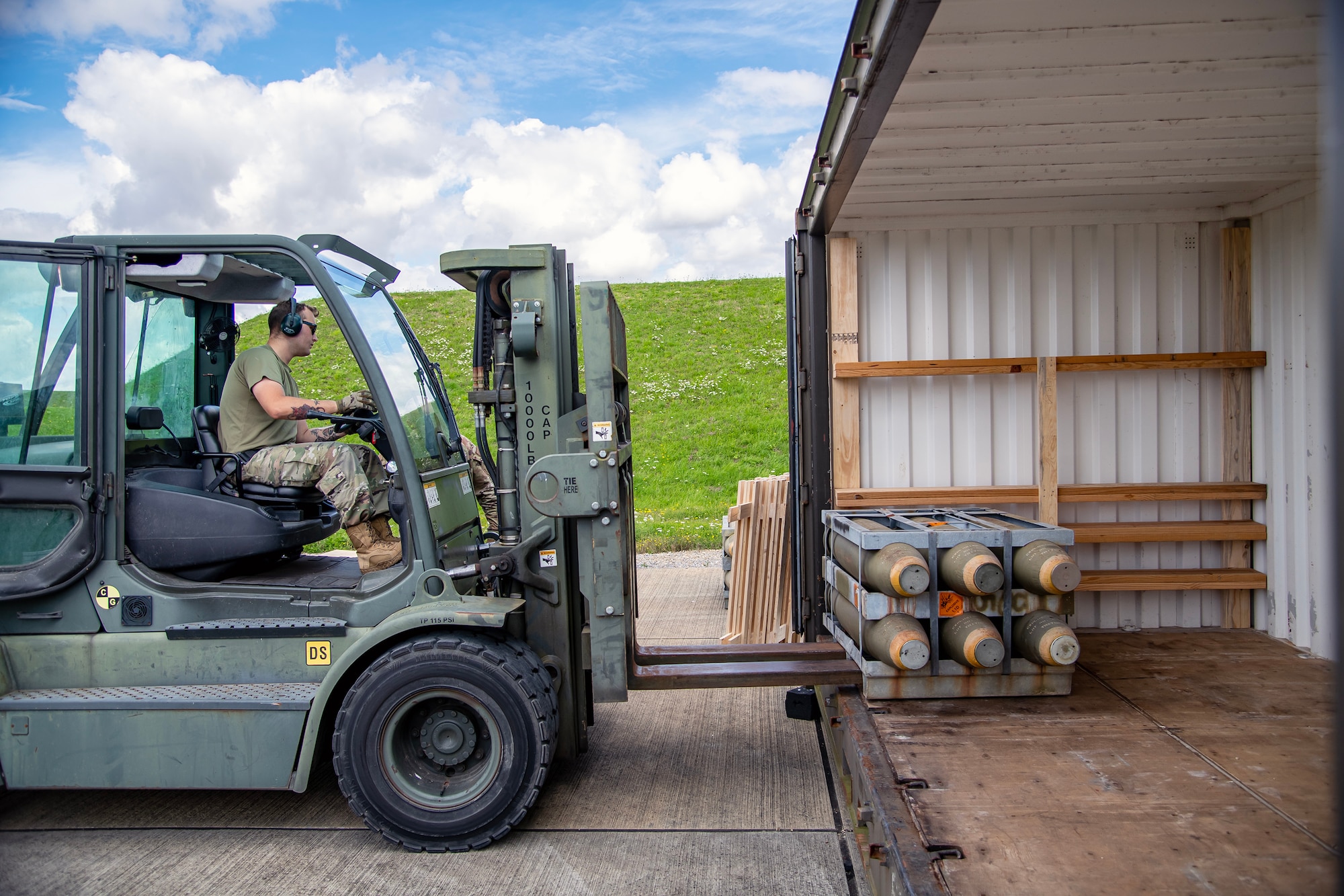 An Airman from the 420th Munitions Squadron utilizes a forklift to place munitions inside an International Standards Organization-container at RAF Welford, England, Aug. 7, 2023. The 420th MUNS conducted operations in support of a week-long Combat Ammunition Production Exercise, which helped strengthen their combat planning and production concepts. (U.S. Air Force photo by Staff Sgt. Eugene Oliver)