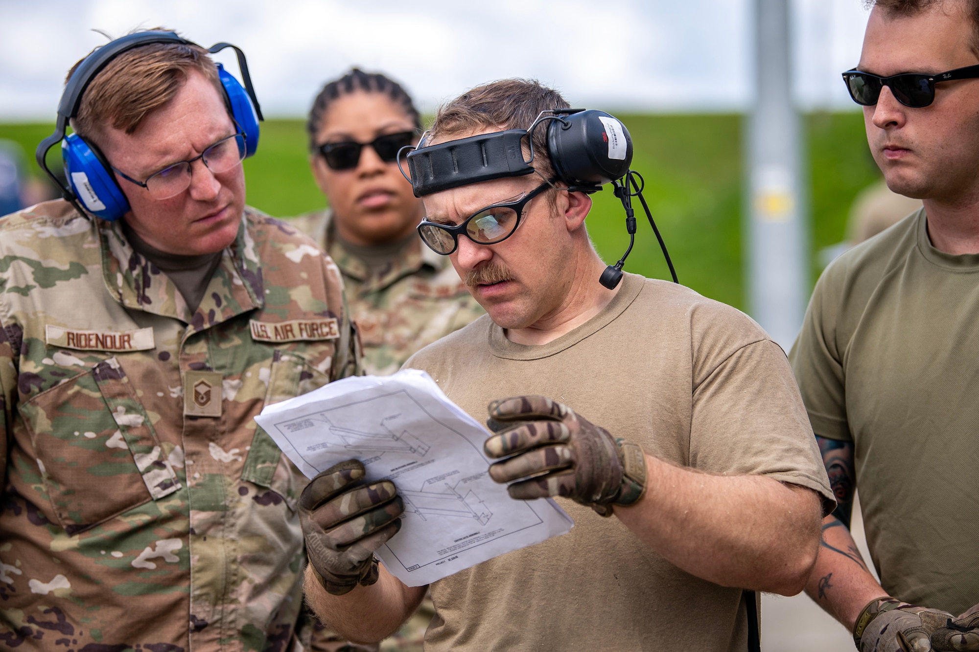 Airmen from the 420th Munitions Squadron read a technical order at RAF Welford, England, Aug. 7, 2023. The 420th MUNS conducted operations in support of a week-long Combat Ammunition Production Exercise, which helped strengthen their combat planning and production concepts. (U.S. Air Force photo by Staff Sgt. Eugene Oliver)