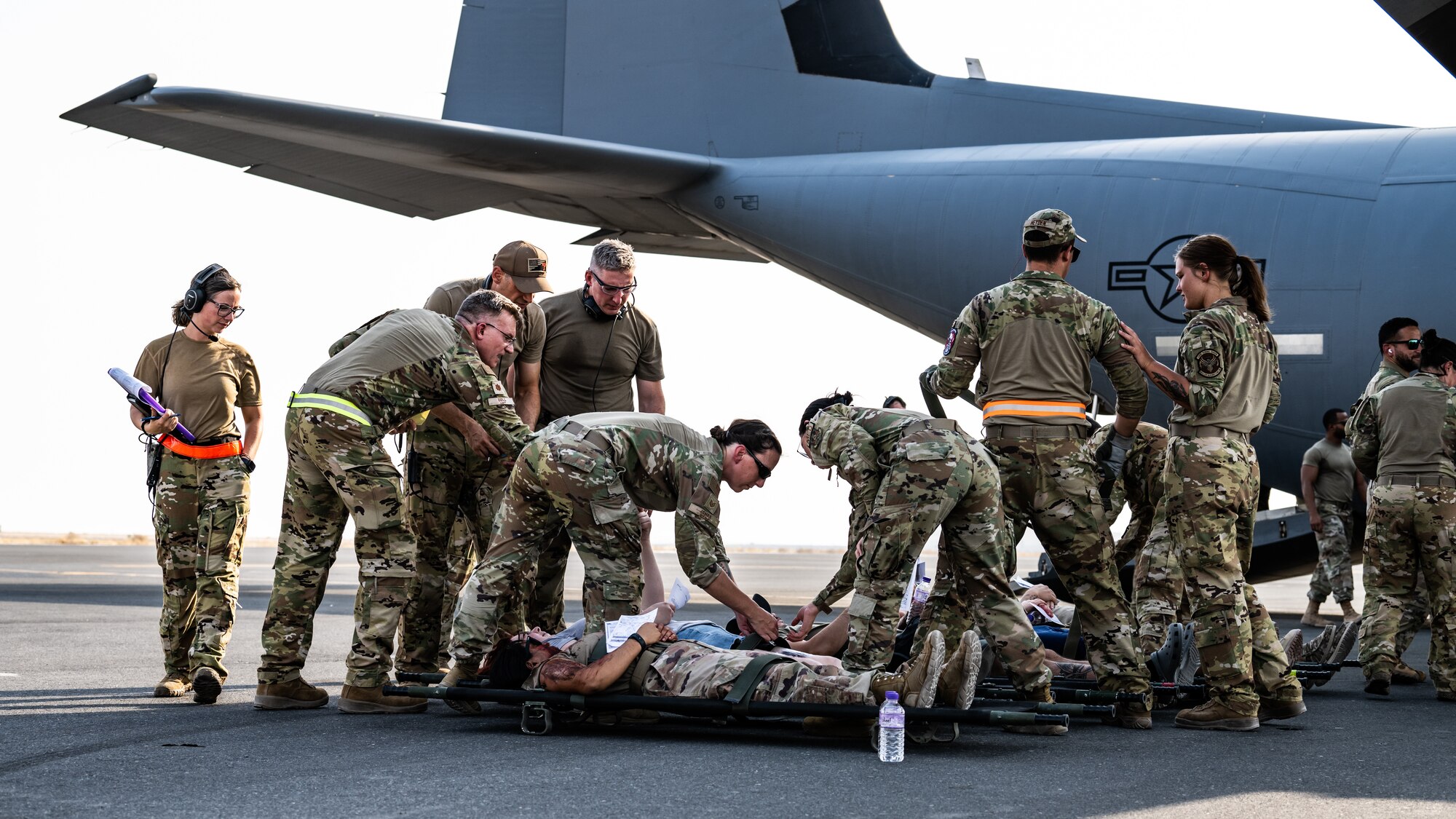 U.S. Air Force medical personnel from the 386th Expeditionary Medical Squadron field response team and the 405th Expeditionary Aeromedical Evacuation Squadron prepare to load victims from a simulated attack onto a C-130J Super Hercules during a contingency response development at Ali Al Salem Air Base, Kuwait, Aug. 9, 2023. This simulated mass-casualty training event provided joint participants from multiple wings and squadrons with the chance to put their life saving medical capabilities to the test, ensuring the safety of the U.S. and coalition forces here at ASAB. (U.S. Air Force photo by Staff Sgt. Kevin Long)