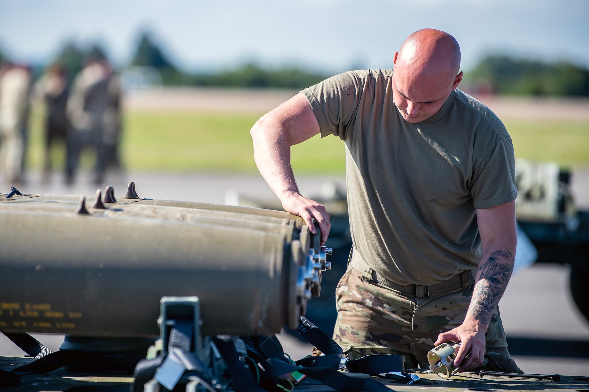 A U.S. Air Force Airman builds a munition at RAF Fairford, England, Aug. 10, 2023. Members from the 48th Fighter Wing, 501st Combat Support Wing, 28th Bomb Wing and Royal Air Force conducted munitions builds and transports in support of a week-long Combat Ammunition Production Exercise. The exercise provided them an opportunity to evaluate munitions combat readiness, base support plan adequacy, tactics, techniques and procedures and enhanced interoperability between NATO forces. (U.S. Air Force photo by Staff Sgt. Eugene Oliver)