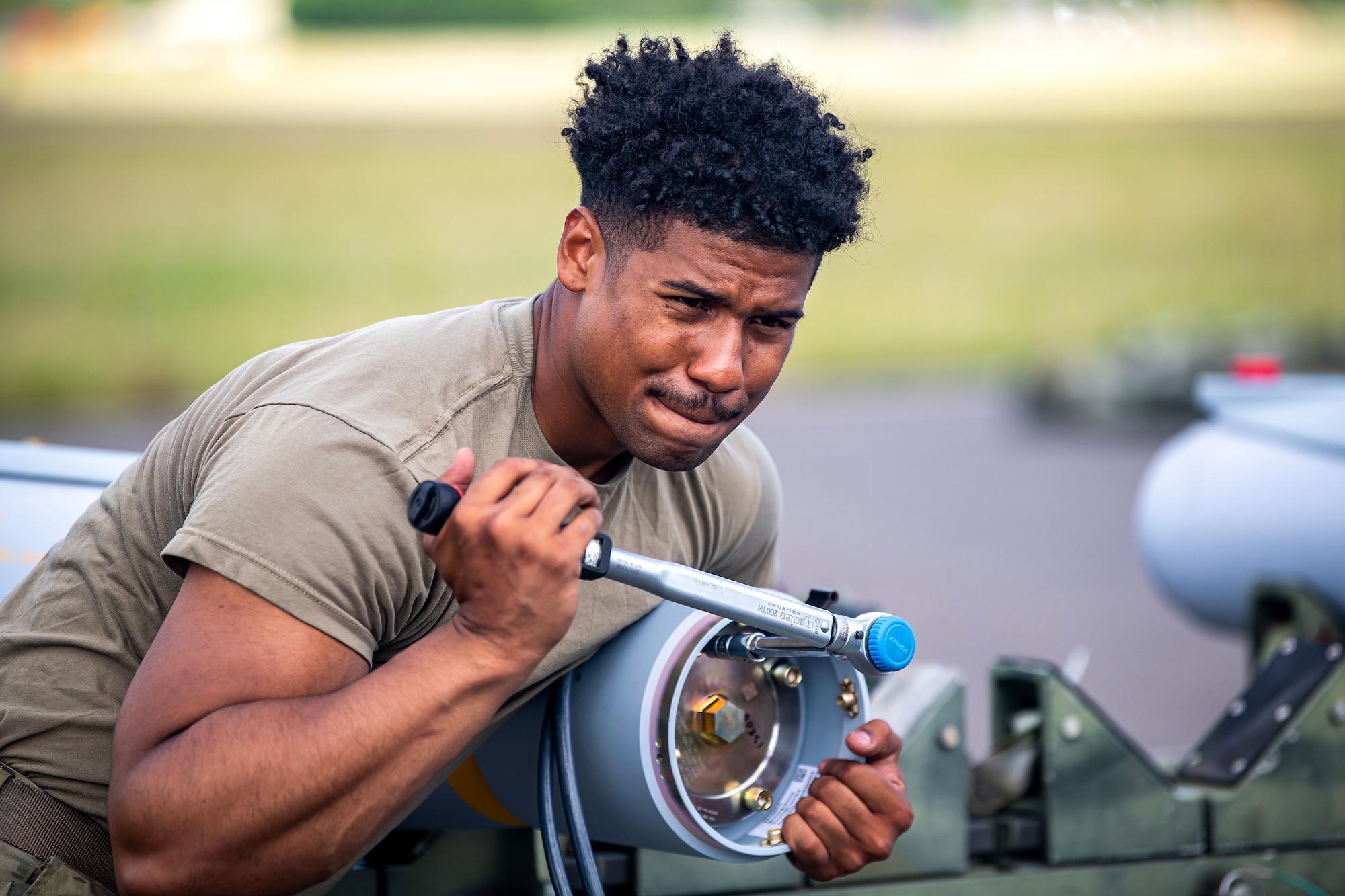 An Airman from the 48th Fighter Wing, assembles a munition at RAF Fairford, England, Aug. 10, 2023. Members from the 48th FW, 501st Combat Support Wing, 28th Bomb Wing and Royal Air Force conducted munitions builds and transports in support of a week-long Combat Ammunition Production Exercise. The exercise provided them an opportunity to evaluate munitions combat readiness, base support plan adequacy, tactics, techniques and procedures and enhanced interoperability between NATO forces. (U.S. Air Force photo by Staff Sgt. Eugene Oliver)
