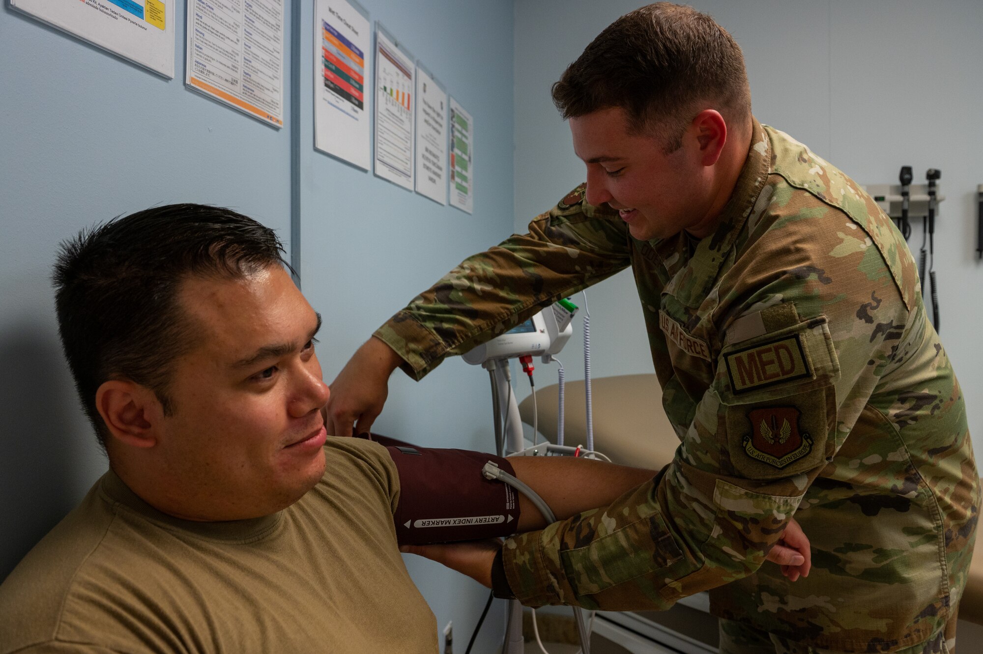 A medical technician checks a man's blood pressure.