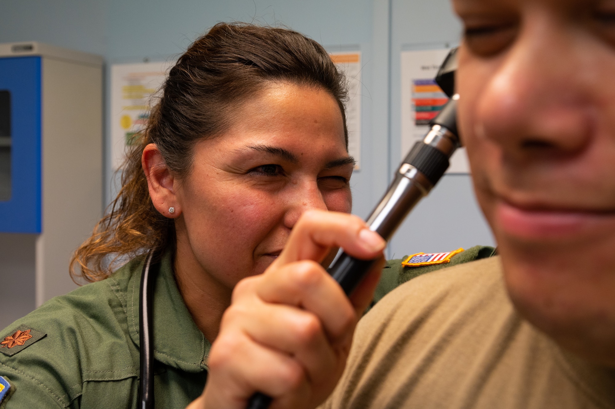 A medical provider checks a persons ear.