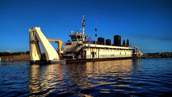 Big boat in the water moving river sand