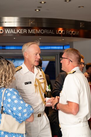 Vice Admiral Johnny Wolfe Jr., director of U.S. Navy Strategic Systems Programs (SSP) (right) greets UK Navy Commodore Roger Readwin (middle), the British Embassy's Naval Attaché, at the Navy Memorial in Washington, D.C. The U.S. and British Navy share a special partnership through the Polaris Sales Agreement between the two countries. Vice Adm. Wolfe hosted the Concert on The Avenue, played by the U.S. Navy Band, which featured the storyline and history of the Navy set to the tune of patriotic music (U.S. Navy Photo by Lt. Jennifer Bowman)
