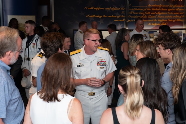 Vice Admiral Johnny Wolfe Jr., director of U.S. Navy Strategic Systems Programs (SSP) (center) visits with a group of students during a reception for the SSP workforce and other attendees at the Navy Memorial in Washington, D.C. Vice Adm. Wolfe hosted the Concert on The Avenue, played by the U.S. Navy Band, which featured the storyline and history of the Navy set to the tune of patriotic music (U.S. Navy Photo by Lt. Jennifer Bowman)