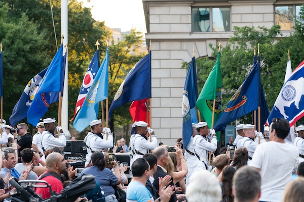 The Navy Ceremonial Guard presents the colors before the U.S. Navy Band plays its Concert on the Avenue (COTA) at the Navy Memorial in Washington, D.C. Vice Admiral Johnny Wolfe Jr., director of U.S. Navy Strategic Systems Programs (SSP) hosted the concert, played by the Navy Band for the public, which featured the storyline and history of the Navy set to the tune of patriotic music (U.S. Navy Photo by Lt. Jennifer Bowman)