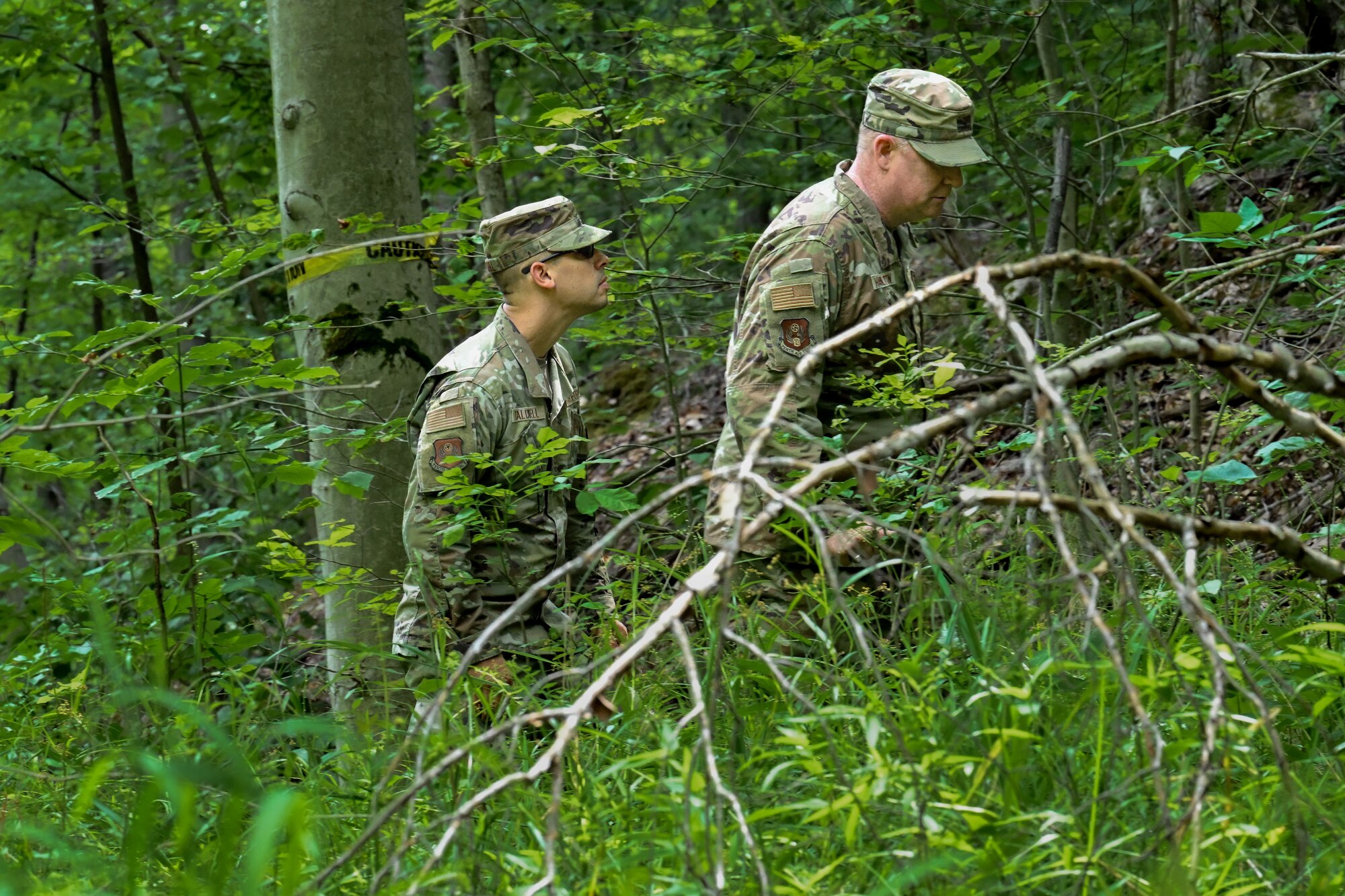 Chief Master Sgt. Michael Caldwell, Tenth Air Force Security Forces Manager, and Col. Robert Hamilton, Tenth Air Force Deputy Director of Logistics, Engineering and Force Protection, observe an Integrated Defense Leadership Course area security operations exercise on July 27, 2023, at Camp James A. Garfield Joint Military Training Center, Ohio.