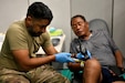 U.S. Army Reserve Lt. Col. Ali Turabi, an anesthesiologist, 338th Medical Brigade performs a joint aspiration on a community member Carl Rozanski during Guam Wellness Innovative Readiness Training (IRT) to alleviate knee pain, 05 Aug. IRT is a collaborative program that leverages military contributions and community resources to multiply value and cost savings for participants. Guam Wellness IRT is a collaborative partnership with the Department of Public Health and Social Services to provide no cost healthcare services to include medical, dental, optometry, and immunizations to the communities of Guam Aug. 2-10, 2023. (U.S. Army Reserve Photo by Maj. Chelsea Kersten)