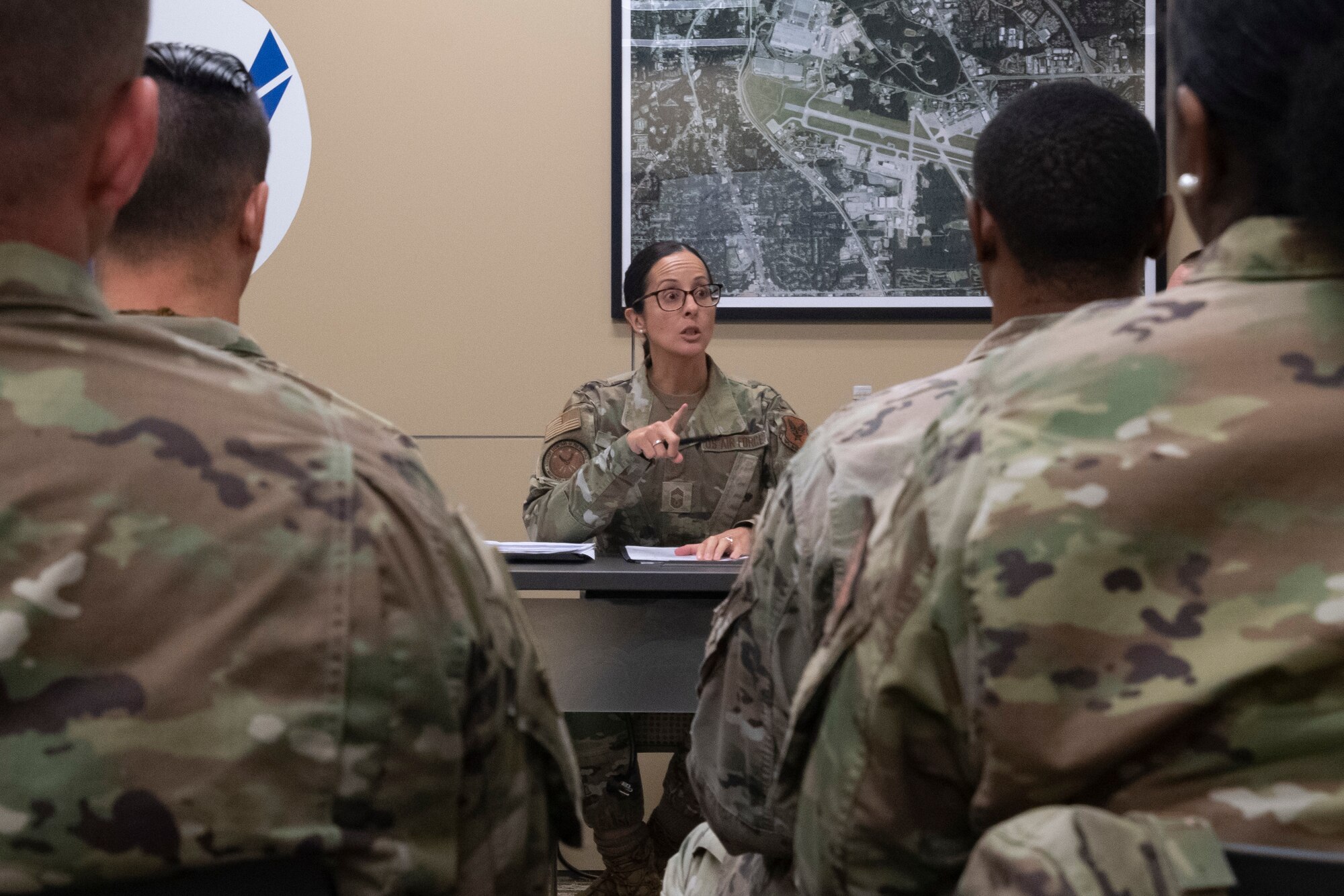 A woman speaks to a classroom of students