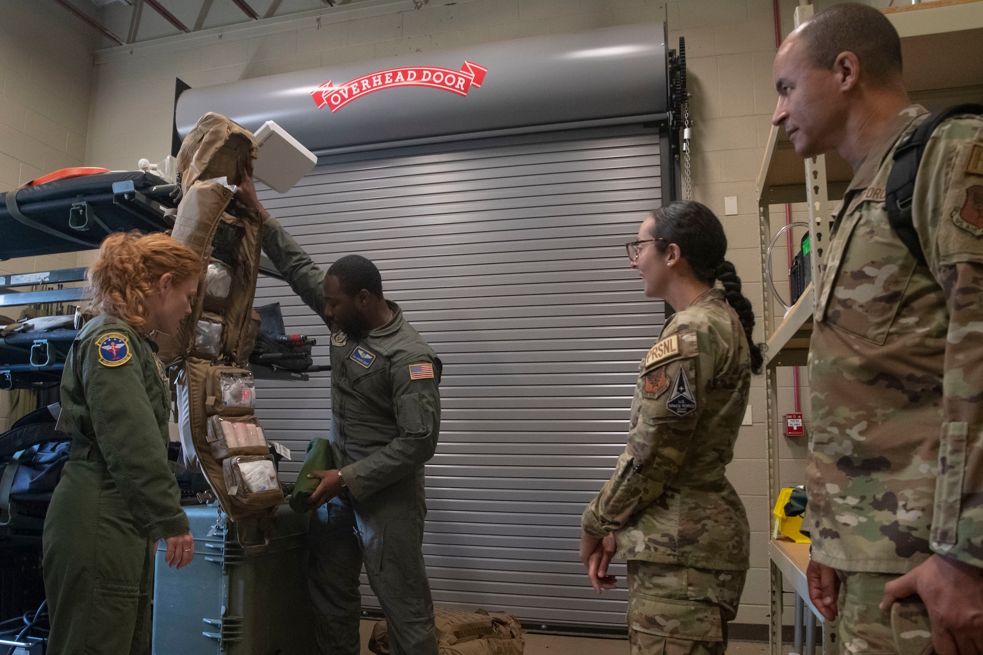 Two people unpack a medical bag while others watch
