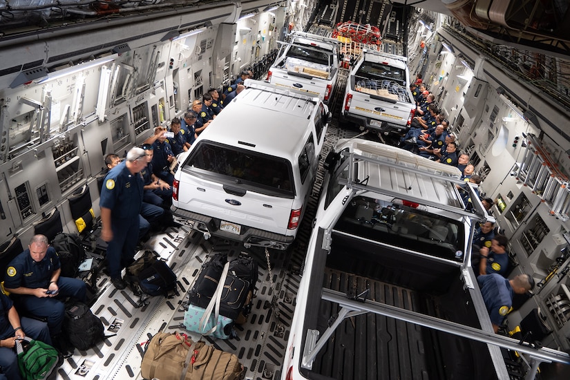 Personnel and vehicles are transported in a military helicopter.