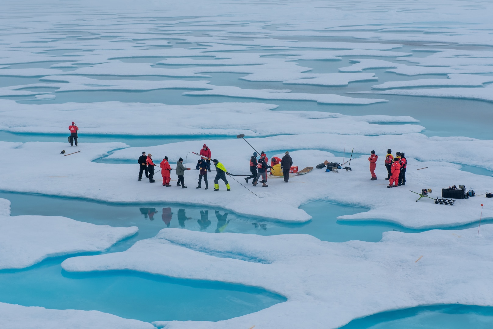 A U.S. Coast Guard Cutter Healy (WAGB 20) crew and researchers install equipment on a floe of multi-year ice in the Beaufort Sea, Aug. 9, 2023. Healy is the Coast Guard’s only icebreaker specifically designed for Arctic research, as well as the nation’s sole surface presence routinely operating in the Arctic Ocean.  (Coast Guard photo by Petty Officer 3rd Class Briana Carter)
