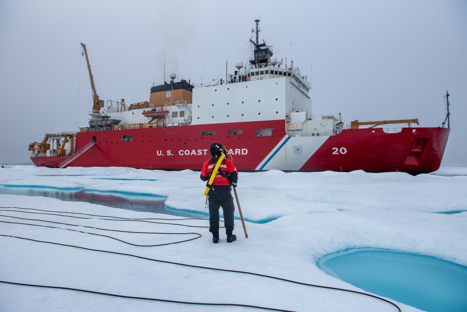 A member of the ice rescue team maintains look-out as U.S. Coast Guard Cutter Healy (WAGB 20) keeps station alongside a multi-year ice floe for a science evolution on in the Beaufort Sea, Aug. 9, 2023. Healy is the Coast Guard’s only icebreaker specifically designed for Arctic research, as well as the nation’s sole surface presence routinely operating in the Arctic Ocean. (Coast Guard photo by Petty Officer 3rd Class Briana Carter)