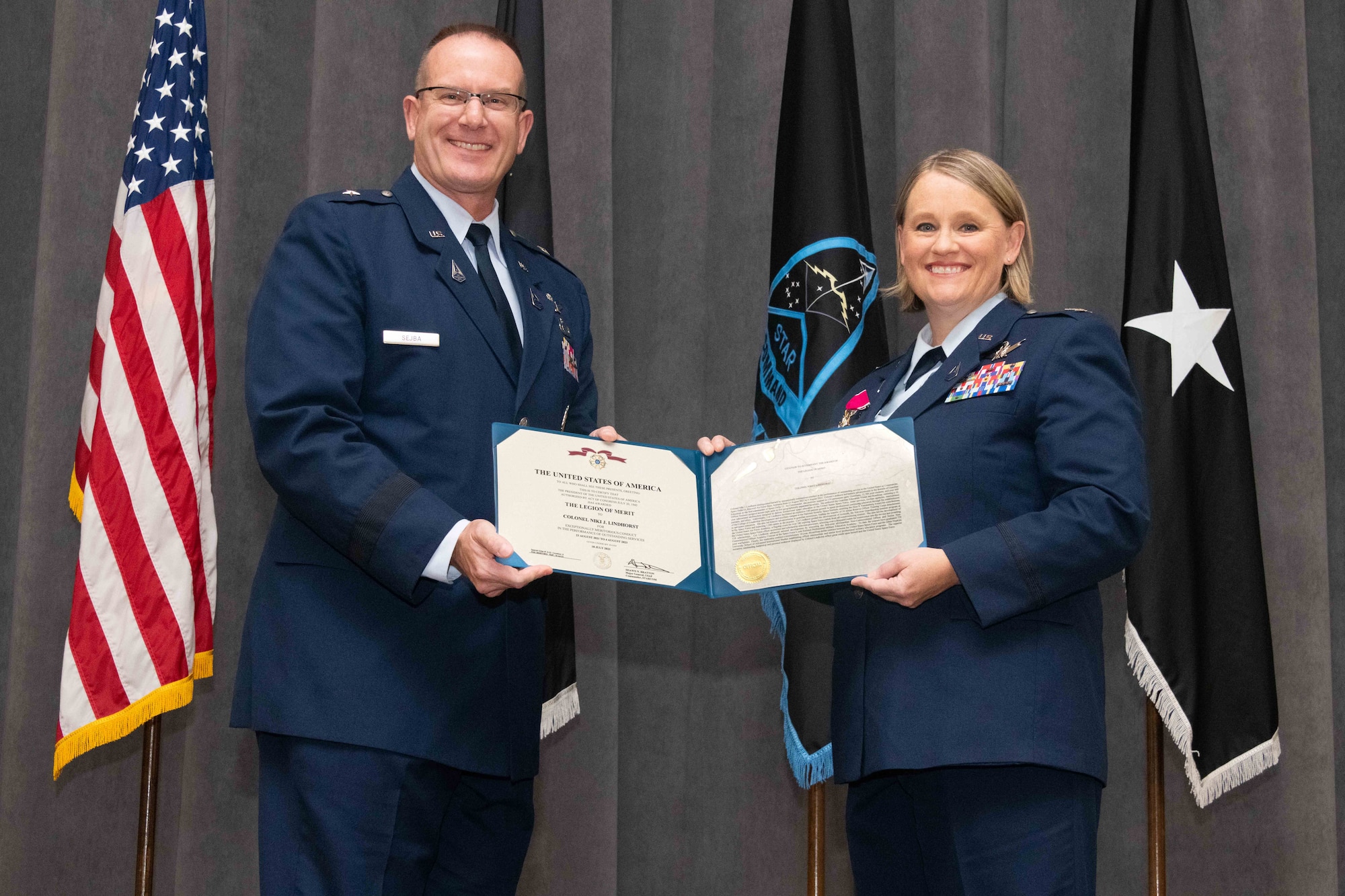 U.S. Space Force Brig. Gen. Timothy Sejba, Commander of Space Training and Readiness Command, presents the Legion of Merit medal to U.S. Space Force Col. Niki Lindhorst, outgoing Delta 13 commander, during a change of command ceremony at Maxwell Air Force Base, Ala., Aug. 4, 2023. Delta 13 is the U.S. Space Force's Delta responsible for space education. (U.S. Air Force photo by Sean Ross)