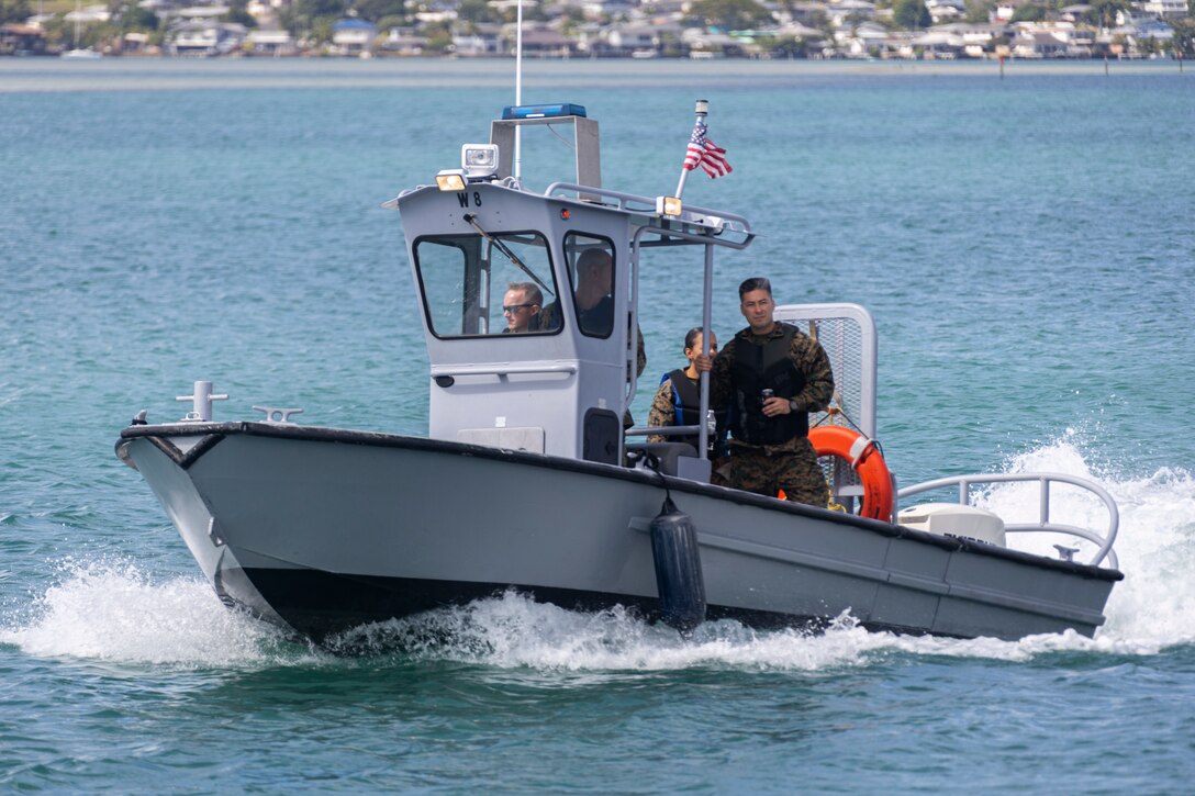 U.S. service members aboard Marine Corps Base Hawaii supervise a fuel pier booming exercise, MCBH, August 3, 2023. The purpose of this exercise was to practice protecting environmental, cultural, economic and home communities in Kaneohe Bay from oil spills. (U.S. Marine Corps photo by Lance Cpl. Hunter Jones)