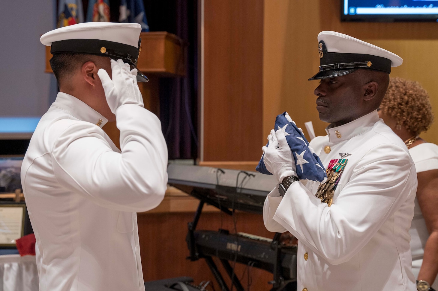 Fleet Command Master Chief Huben Phillips receives a folded flag during the flag passing ceremony of his retirement ceremony, Aug. 11, 2023.