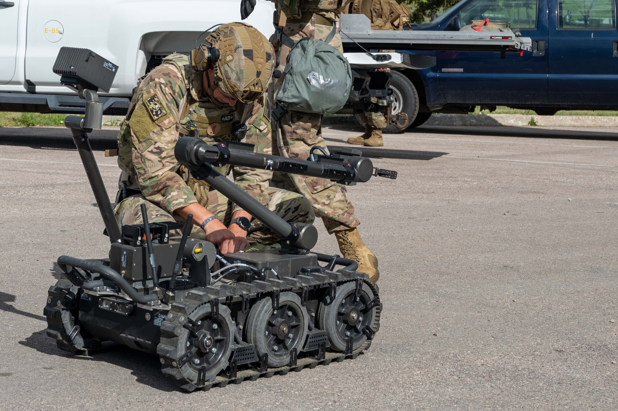 An Airman with the 28th Civil Engineering Squadron, explosives ordinance disposal flight, prepares a remote-control robot to survey for threats before personnel enter an area on Ellsworth Air Force Base, South Dakota, July 25, 2023. Robots are utilized to locate and identify explosive threats without endangering the lives of Airmen. (U.S. Air Force photo by Specialist 3 Adam Olson)