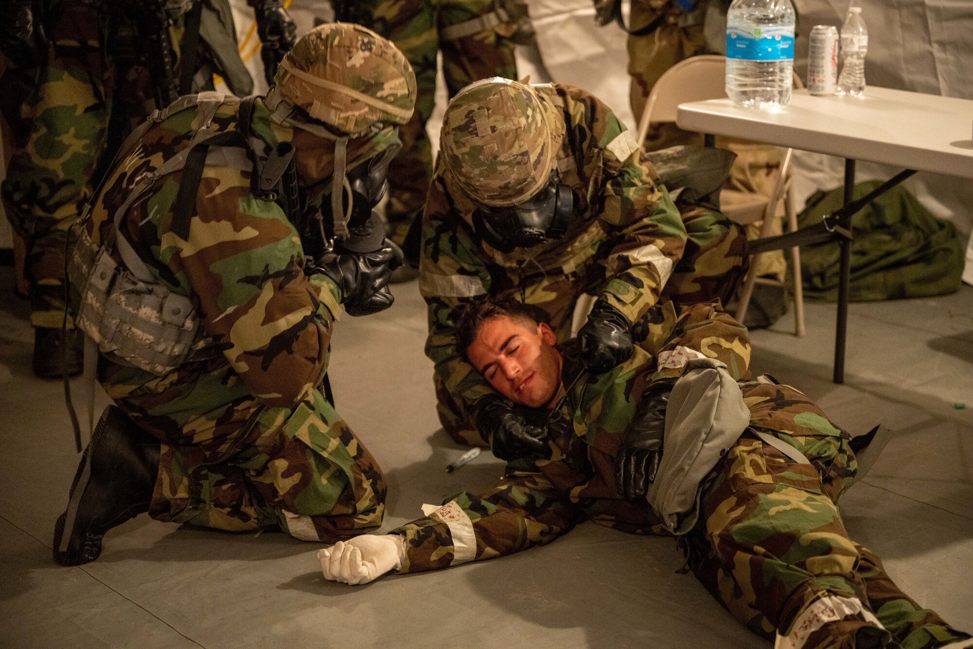 Airmen with the 28th Civil Engineering Squadron tend to a simulated poisoned casualty during an exercise on Ellsworth Air Force Base, South Dakota, July 26, 2023. The simulated casualty chewed an effervescent tablet mimic the recognizable ‘foaming of the mouth’ common in most poisonings. (U.S. Air Force Photo by Specialist 3 Adam Olson)