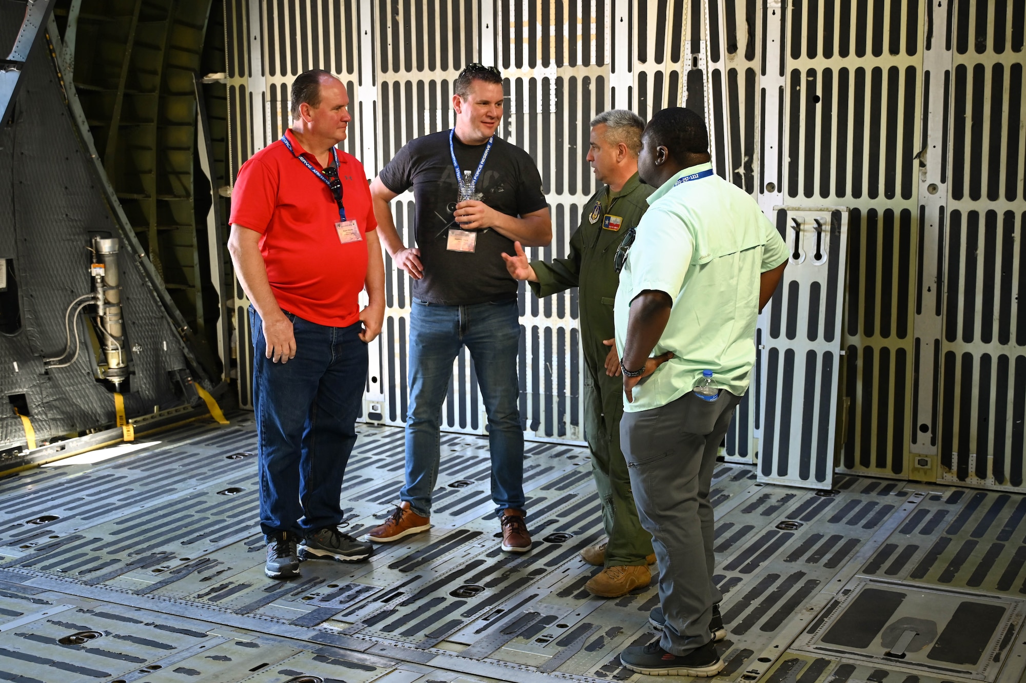 Senior Master Sgt. Ernest Urrutia, 68th Airlift Squadron flight engineer evaluator, greets employers participating in the Bosslift program aboard a C-5M Super Galaxy at Joint Base San Antonio-Lackland, Texas on Saturday, Aug. 5, 2023. The program, hosted by the 433rd Airlift Wing in conjunction with Employer Support of the Guard and Reserve, gave civilian employers of Reserve Citizen Airmen an opportunity to see what reservists do during monthly Unit Training Activities. (U.S. Air Force Photo by Julian Hernandez)