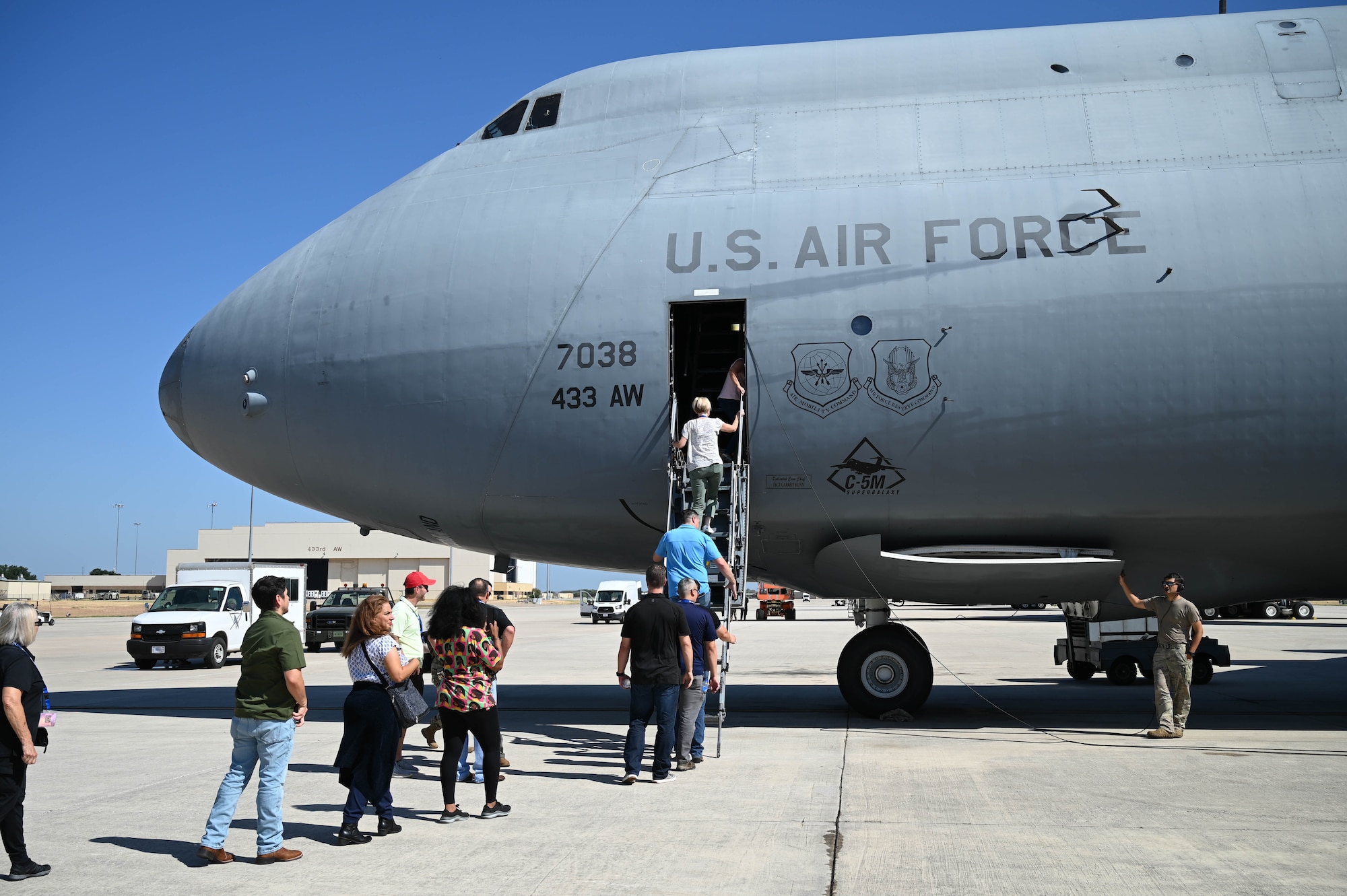 Employers nominated to participate in the Employer Support of the Guard and Reserve Bosslift program board a C-5M Super Galaxy at Joint Base San Antonio-Lackland, Texas on Saturday Aug. 5, 2023. The program, hosted by the 433rd Airlift Wing in conjunction with ESGR, gave civilian employers of Reserve Citizen Airmen an opportunity to see what reservists do during monthly Unit Training Activities. (U.S. Air Force Photo by Julian Hernandez)