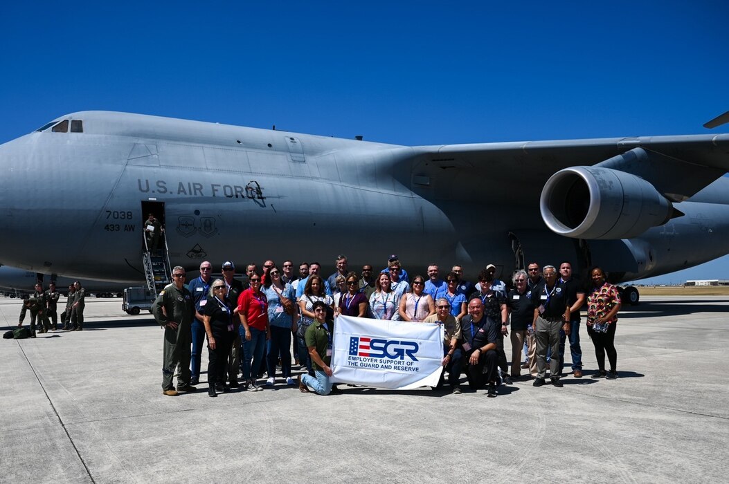 Col. Brendon Bartholomew (far left), 433rd Airlift Wing deputy commander, stands with participants of the 433rd Airlift Wing Employer Support of the Guard and Reserve Bosslift event at Joint Base San Antonio-Lackland, Texas, Aug. 5, 2023. Civilian employers of Reserve Citizen Airmen received a first-hand look at what their reservist employees do during their military duty. The event included a flight on a C-5M Super Galaxy aircraft, and visits to the wing’s pilot simulators and engine shop. (U.S. Air Force photo by Staff Sgt. Adriana Barrientos)
