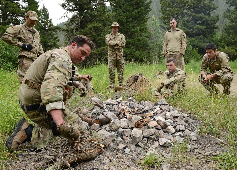 A group of 6 men surround a campfire.