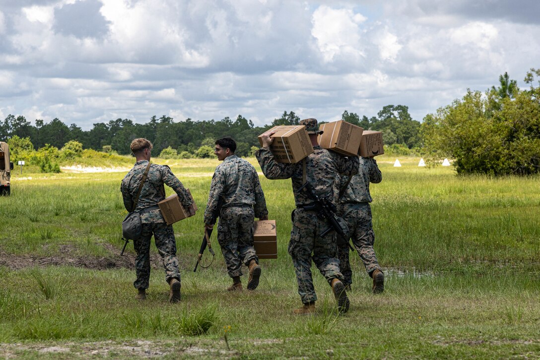 U.S. Marines with Combat Logistics Battalion 24 (CLB-24), Combat Logistics Regiment 2, 2nd Marine Logistics Group, carry boxes of Meals Ready to Eat (MRE) during a Marine Corps Combat Readiness Evaluation (MCCRE) on Camp Lejeune, North Carolina, July 31, 2023. CLB-24’s MCCRE is the battalion's final evaluation to demonstrate combat readiness through proficiency in core mission essential tasks before they begin a change of operational control to the 24th Marine Expeditionary Unit. (U.S. Marine Corps photo by Lance Cpl. Alfonso Livrieri)