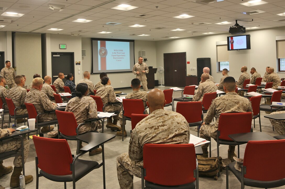 Brigadier Gen. Vincent A. Coglianese, commanding general, 1st Marine Logistics Group, speaks with Marines and sailors attending an Equal Opportunity Representative Course aboard Camp Pendleton, Calif., Oct. 28, 2013. The five-day course qualifies staff noncommissioned officers as equal opportunity representatives that support fair work environments and manage their command's EO program. (U.S. Marine Corps photo by Lance Cpl. Shaltiel Dominguez/ Released)