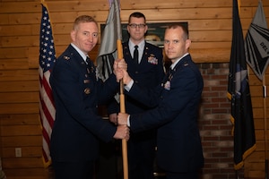 Service members posing for a photo at a change of command