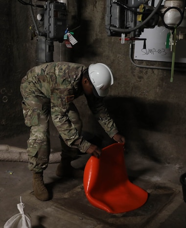 A service member assigned to Joint Task Force-Red Hill (JTF-RH) applies a cover to a monitoring well during the implementation of additional aquifer protective measures at the Red Hill Bulk Fuel Storage Facility (RHBFSF), Halawa, Hawaii, Aug. 10, 2023. JTF-RH is in phase three of its five-phase defueling plan. Personnel are focused on completing quality control tasks, training, response preparation, the National Environmental Policy Act Environmental Assessment, regulatory approvals and operational planning for all major milestones. This extensive preparatory work will help ensure the safe and expeditious defueling of the RHBFSF. (DoD photo by U.S. Army Staff Sgt. Randall E. Corpuz)