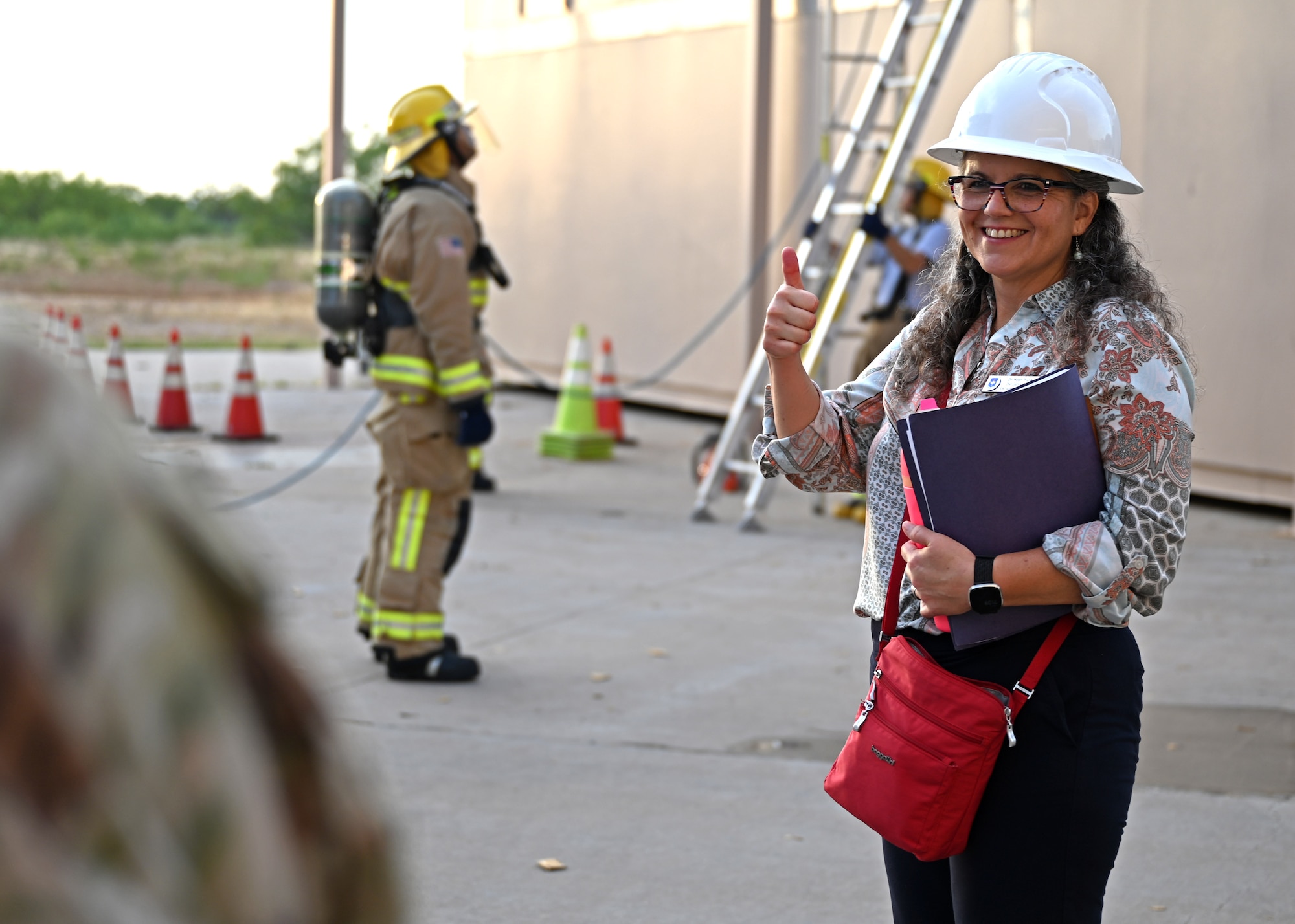 Dr. Wendy Walsh, Air Education and Training Command chief learning officer, gives a thumbs up at the Louis F. Garland Department of Defense Fire Academy, Goodfellow Air Force Base, Texas, Aug. 8, 2023. The Louis F. Garland DoD Fire Academy is the largest fire training facility in the world and graduates over 1,400 joint service students each year. (U.S. Air Force photo by Senior Airman Sarah Williams)