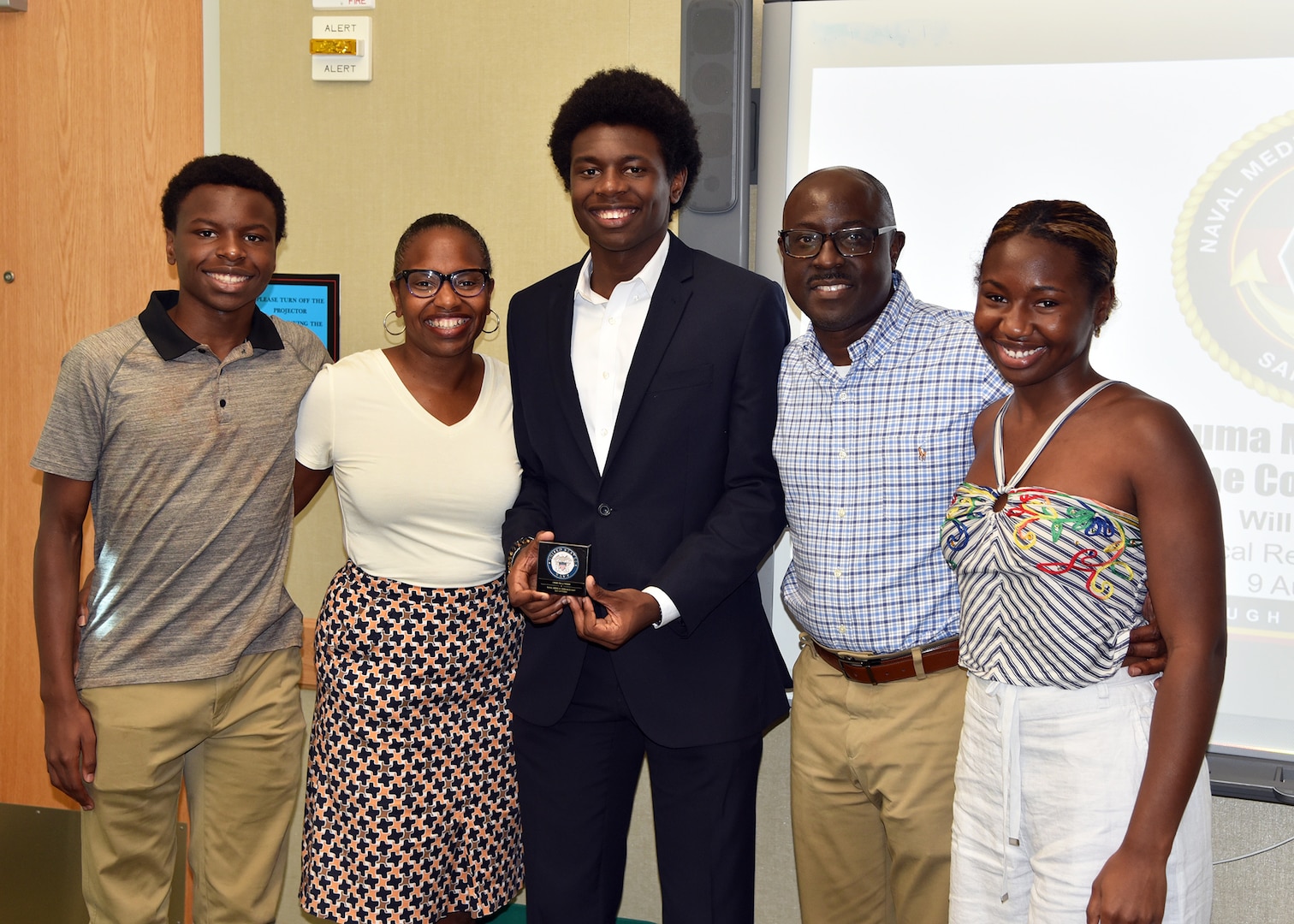 JOINT BASE SAN ANTONO-FORT SAM HOUSTON – (Aug. 9, 2023) – Pennsylvania State University sophomore William Hervey, of San Antonio, an Oak Ridge Institute for Science and Education (ORISE) intern assigned to Naval Medical Research Unit (NAMRU) San Antonio’s Biomedical Systems Engineering and Evaluation Department, with his parents and siblings after presenting his research titled “Development of a Trauma Manikin for Test and Evaluation in Extreme Cold Environments” to researchers and NAMRU San Antonio leadership at the Battlefield Health and Trauma Research Institute. ORISE is a U.S. Department of Energy asset that is dedicated to enabling critical scientific, research, and health initiatives of the department and its laboratory system by providing world class expertise in STEM workforce development, scientific and technical reviews, and the evaluation of radiation exposure and environmental contamination. NAMRU San Antonio is one of the leading research and development laboratories for the U.S. Navy under the Department of Defense (DoD) and is one of eight subordinate research commands in the global network of laboratories operating under the Naval Medical Research Command in Silver Spring, Md.  Its mission is to conduct gap driven combat casualty care, craniofacial, and directed energy research to improve survival, operational readiness, and safety of DoD personnel engaged in routine and expeditionary operations. (U.S. Navy photos by Burrell Parmer, NAMRU San Antonio Public Affairs/Released)